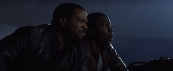 Movie still from “Ride Along” (2014), directed by Tim Story – A couple of men sitting next to each other; Close Up shot, Over the shoulder angle
