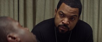 Movie still from “Ride Along” (2014), directed by Tim Story – A man with a goatee looking at the camera; Close Up shot, Over the shoulder angle