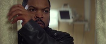 Movie still from “Ride Along” (2014), directed by Tim Story – A person wearing a black leather jacket; Close Up shot, Over the shoulder angle