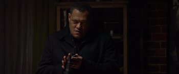 Movie still from “Ride Along” (2014), directed by Tim Story – A man in a black jacket looking at a cell phone; Close Up shot, Over the shoulder angle