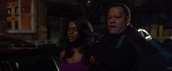 Movie still from “Ride Along” (2014), directed by Tim Story – A woman and a man holding a handgun in the dark; Medium shot, Over the shoulder angle