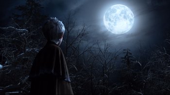 Movie still from “Rise of the Guardians” (2012), directed by Peter Ramsey – A person standing in the woods under a full moon; Wide shot, Low angle