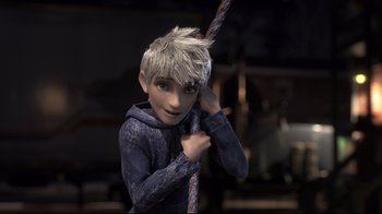 Movie still from “Rise of the Guardians” (2012), directed by Peter Ramsey – A young boy with spiky hair holding onto a rope; Medium shot, Over the shoulder angle