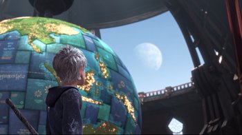 Movie still from “Rise of the Guardians” (2012), directed by Peter Ramsey – A woman standing in front of a globe with a moon in the background; Medium shot, Low angle