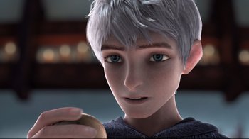Movie still from “Rise of the Guardians” (2012), directed by Peter Ramsey – A boy with blue eyes holding an apple in his hand; Close Up shot, Over the shoulder angle
