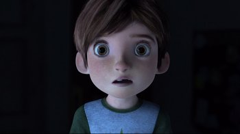 A cartoon boy with big brown eyes stares at the camera