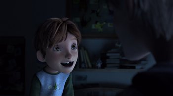Movie still from “Rise of the Guardians” (2012), directed by Peter Ramsey – A boy is smiling at the camera in the dark; Close Up shot, Over the shoulder angle
