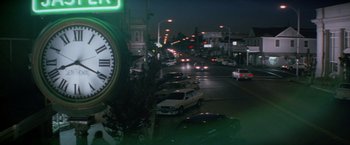 Movie still from “Road House” (1989), directed by Rowdy Herrington – A street scene with cars driving down the road; Extreme Wide shot, Low angle