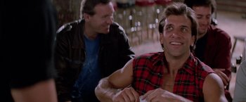 Movie still from “Road House” (1989), directed by Rowdy Herrington – Two men sitting in front of each other in a restaurant; Close Up shot, Low angle