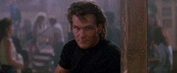 Movie still from “Road House” (1989), directed by Rowdy Herrington – A person wearing a black shirt; Close Up shot, Low angle