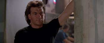 Movie still from “Road House” (1989), directed by Rowdy Herrington – A person raising his arm; Close Up shot, Low angle