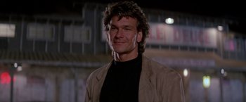 Movie still from “Road House” (1989), directed by Rowdy Herrington – A person wearing a jacket; Close Up shot, Low angle