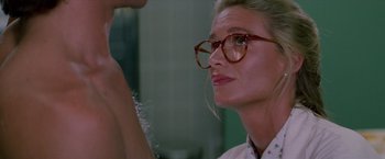 Movie still from “Road House” (1989), directed by Rowdy Herrington – A woman wearing glasses looking at a man; Close Up shot, Over the shoulder angle