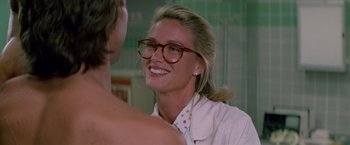 Movie still from “Road House” (1989), directed by Rowdy Herrington – A woman wearing glasses and smiling at a man; Close Up shot, Over the shoulder angle