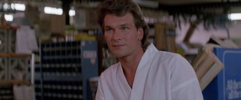 Movie still from “Road House” (1989), directed by Rowdy Herrington – A person wearing a robe; Close Up shot, Over the shoulder angle
