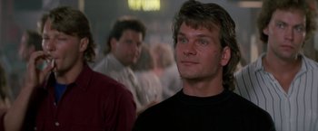 Movie still from “Road House” (1989), directed by Rowdy Herrington – A person wearing a black shirt; Close Up shot, Low angle