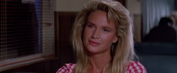 Movie still from “Road House” (1989), directed by Rowdy Herrington – A person with long blonde hair; Close Up shot, Over the shoulder angle