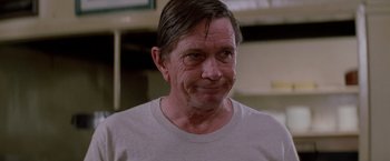 Movie still from “Road House” (1989), directed by Rowdy Herrington – A person wearing a white t - shirt; Close Up shot, Low angle