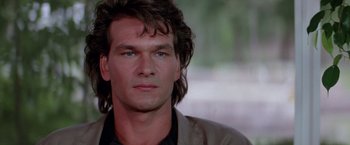 Movie still from “Road House” (1989), directed by Rowdy Herrington – A person with long hair; Close Up shot, Over the shoulder angle