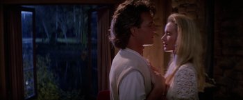 Movie still from “Road House” (1989), directed by Rowdy Herrington – A man and a woman standing next to each other; Close Up shot, Over the shoulder angle