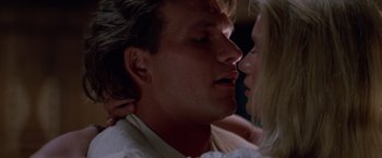 Movie still from “Road House” (1989), directed by Rowdy Herrington – A man and a woman face to face; Close Up shot, Low angle