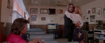 Movie still from “Road House” (1989), directed by Rowdy Herrington – A man is dancing in front of a woman; Medium shot, Low angle