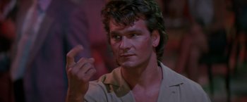 Movie still from “Road House” (1989), directed by Rowdy Herrington – A person holding something in his hand; Close Up shot, Low angle