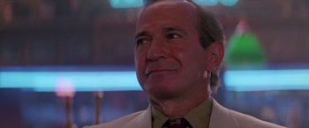 Movie still from “Road House” (1989), directed by Rowdy Herrington – A man in a suit and tie looking to his left; Close Up shot, Low angle