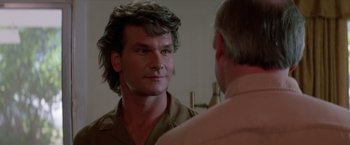 Movie still from “Road House” (1989), directed by Rowdy Herrington – A person in a room with a mirror; Close Up shot, Over the shoulder angle