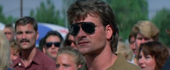 Movie still from “Road House” (1989), directed by Rowdy Herrington – A person wearing sunglasses; Close Up shot, Low angle
