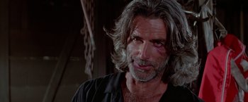 Movie still from “Road House” (1989), directed by Rowdy Herrington – A person wearing a black shirt; Close Up shot, Low angle