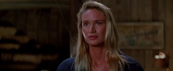 Movie still from “Road House” (1989), directed by Rowdy Herrington – A woman with long blonde hair is looking to her left; Close Up shot, Over the shoulder angle