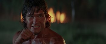 Movie still from “Road House” (1989), directed by Rowdy Herrington – A person with wet hair and a bare torso; Close Up shot, Low angle