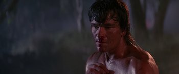 Movie still from “Road House” (1989), directed by Rowdy Herrington – A man with blood all over his face and chest; Close Up shot, Low angle