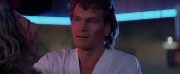 Movie still from “Road House” (1989), directed by Rowdy Herrington – A person with long hair; Close Up shot, Low angle