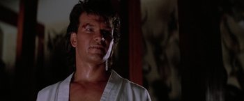 Movie still from “Road House” (1989), directed by Rowdy Herrington – A person wearing a white shirt; Close Up shot, Low angle