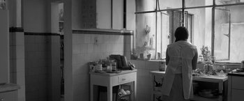 Movie still from “Roma” (2018), directed by Alfonso Cuarón – A kitchen with a sink and a table in it; Medium shot, Low angle