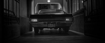 Movie still from “Roma” (2018), directed by Alfonso Cuarón – A black and white photo of a car in a garage; Wide shot, Low angle