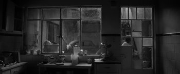 Movie still from “Roma” (2018), directed by Alfonso Cuarón – A black and white photo of a kitchen window; Wide shot, High angle