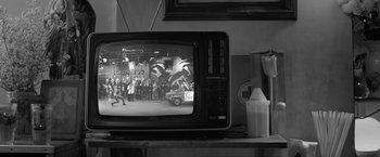 Movie still from “Roma” (2018), directed by Alfonso Cuarón – A black - and - white photo of a television set; Wide shot, High angle