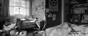 Movie still from “Roma” (2018), directed by Alfonso Cuarón – A black and white photo of a messy bedroom; Wide shot, High angle