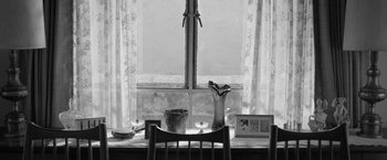 Movie still from “Roma” (2018), directed by Alfonso Cuarón – A black and white photo of a table and chair; Wide shot, High angle