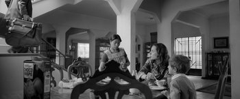 Movie still from “Roma” (2018), directed by Alfonso Cuarón – Two women sitting at a table in a dining room; Medium shot, Over the shoulder angle
