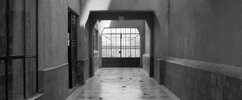 Movie still from “Roma” (2018), directed by Alfonso Cuarón – An open door leading into a building with a tile floor; Extreme Wide shot, High angle