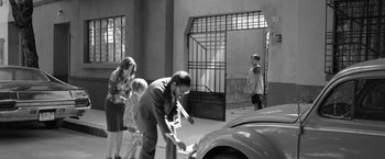 Movie still from “Roma” (2018), directed by Alfonso Cuarón – An old photo of a man and a woman and two children playing baseball; Wide shot, High angle