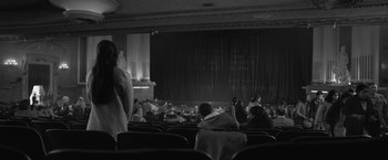 Movie still from “Roma” (2018), directed by Alfonso Cuarón – People are sitting in the auditorium watching a performance; Wide shot, Low angle