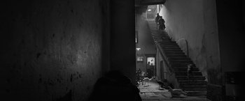Movie still from “Roma” (2018), directed by Alfonso Cuarón – A couple of people are walking down the stairs; Wide shot, High angle