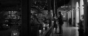 Movie still from “Roma” (2018), directed by Alfonso Cuarón – A man and a woman standing in front of a christmas tree; Wide shot, High angle
