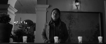 Movie still from “Roma” (2018), directed by Alfonso Cuarón – A woman standing at a counter with a cup of coffee; Medium shot, Low angle
