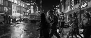 Movie still from “Roma” (2018), directed by Alfonso Cuarón – A black and white photo of a man and a woman walking down a street; Wide shot, Over the shoulder angle